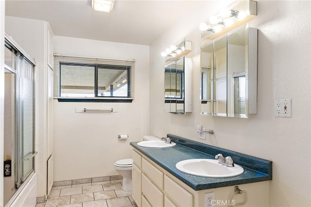 full bathroom featuring enclosed tub / shower combo, vanity, toilet, and tile patterned flooring