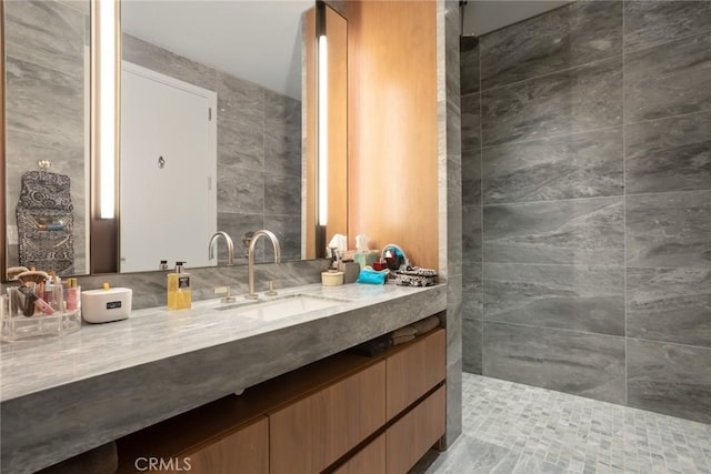 bathroom featuring vanity, tile walls, and walk in shower