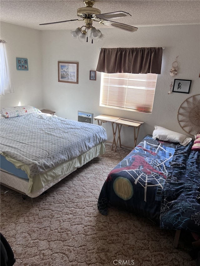 bedroom featuring ceiling fan, a textured ceiling, and carpet floors