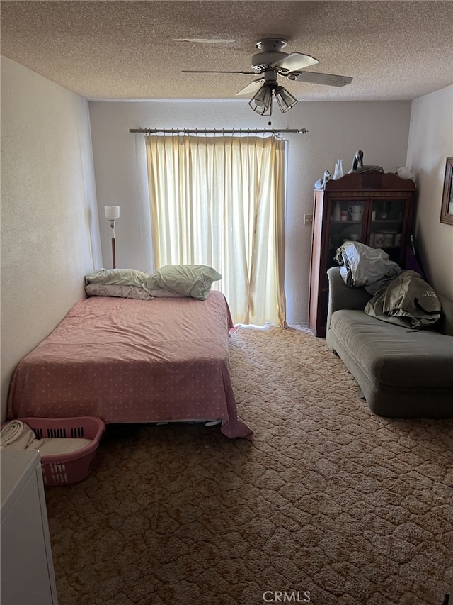 carpeted bedroom with ceiling fan and a textured ceiling