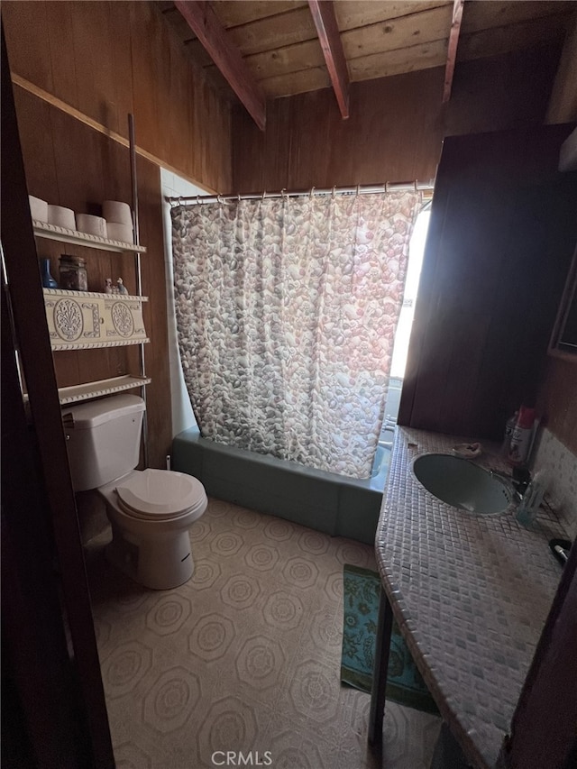 full bathroom featuring toilet, wood walls, wooden ceiling, sink, and beamed ceiling