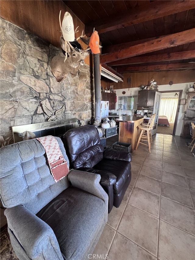 living room with wood ceiling, tile patterned floors, and beamed ceiling