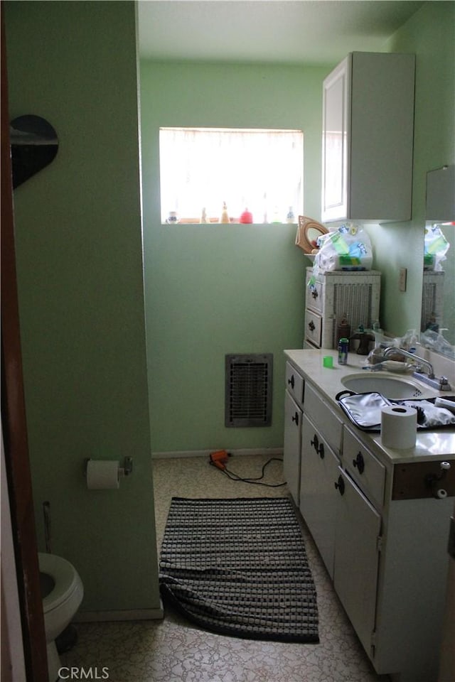 bathroom featuring toilet and vanity