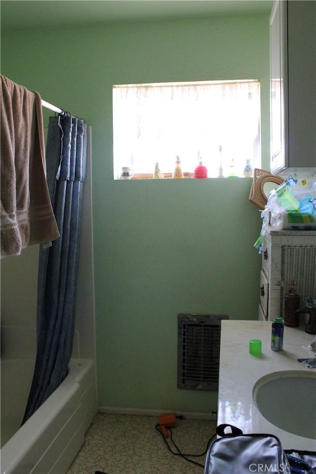 bathroom with shower / bath combo and sink