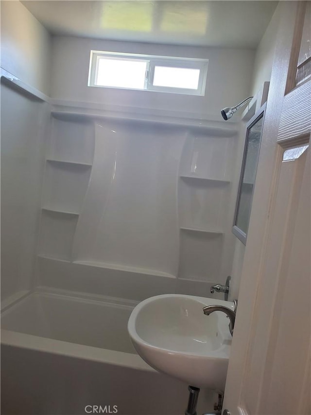 bathroom featuring shower / bathing tub combination and sink