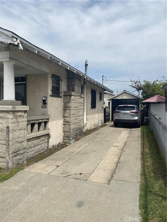 view of side of home with an outbuilding and a garage