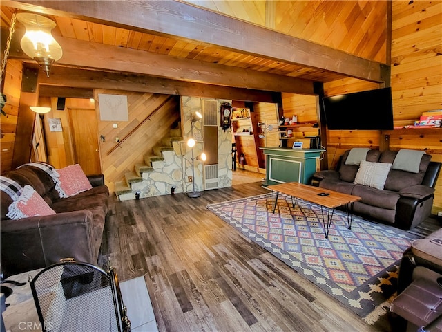 living room featuring beamed ceiling, wood ceiling, wood walls, and wood-type flooring