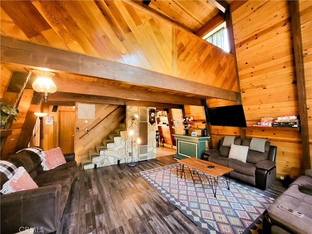 living room with beamed ceiling, hardwood / wood-style floors, and wooden walls