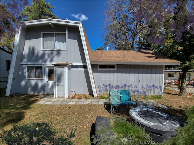 back of property with a lawn