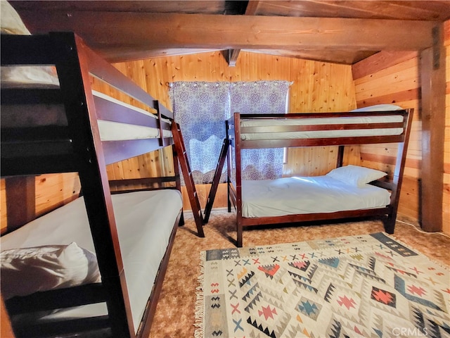 bedroom with beam ceiling and carpet floors