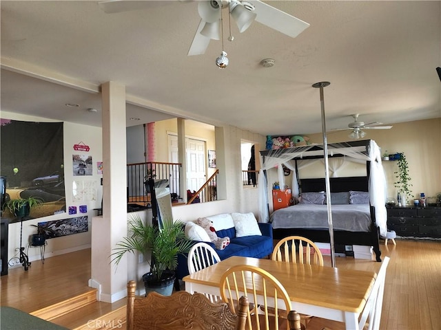 dining area with ceiling fan and wood-type flooring