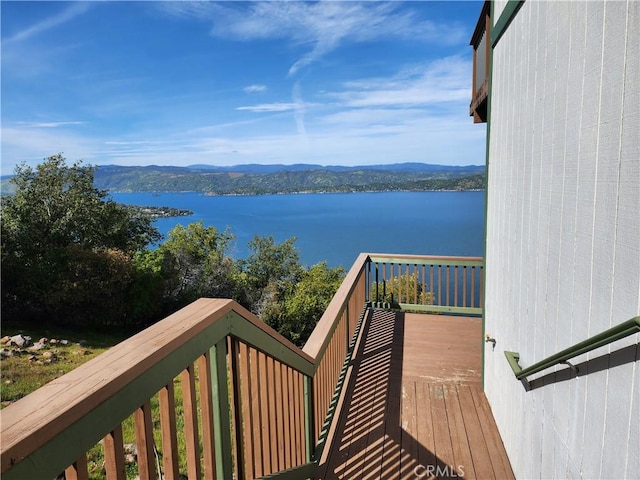 balcony featuring a water and mountain view