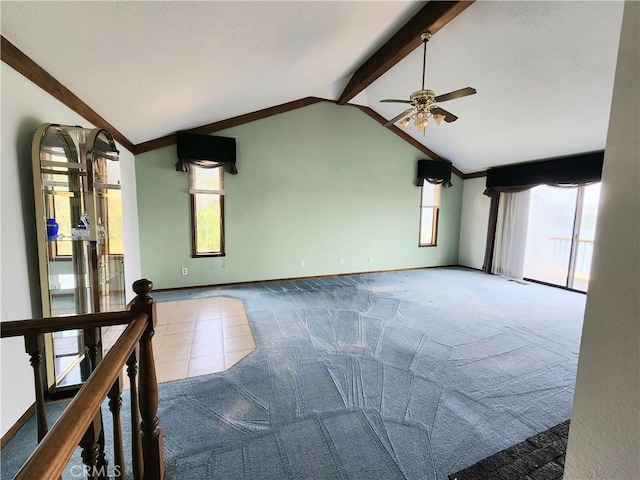 unfurnished living room featuring carpet, vaulted ceiling with beams, and ceiling fan