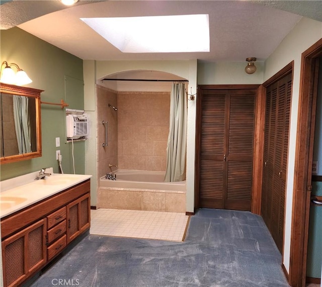 bathroom with a wall mounted AC, shower / tub combo with curtain, and vanity