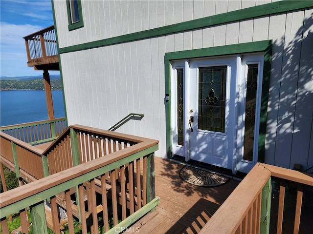 doorway to property featuring a deck with water view