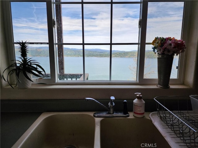 interior details featuring sink and a water view