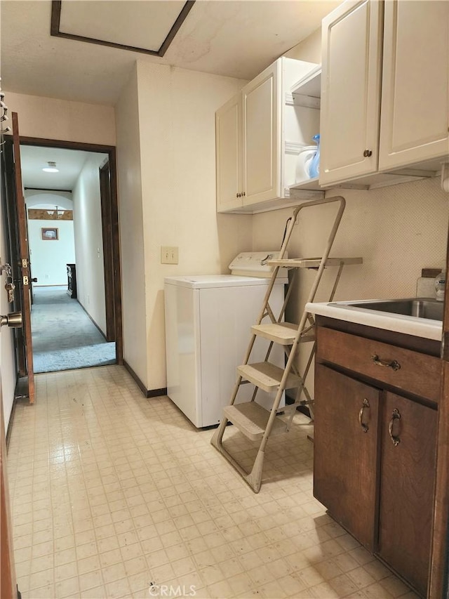 washroom featuring cabinets and washer / dryer