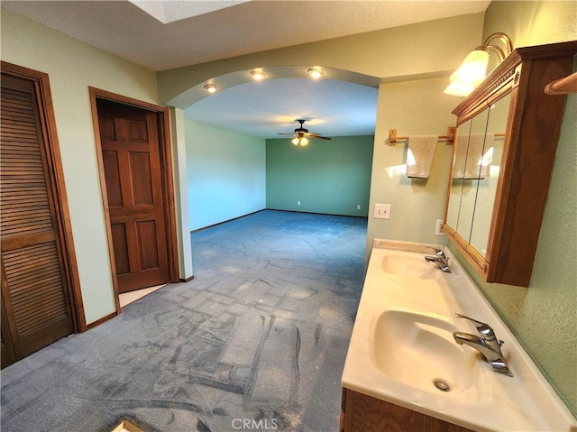 bathroom with ceiling fan and vanity