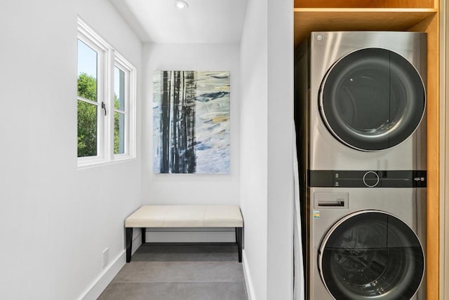 clothes washing area with stacked washer / dryer