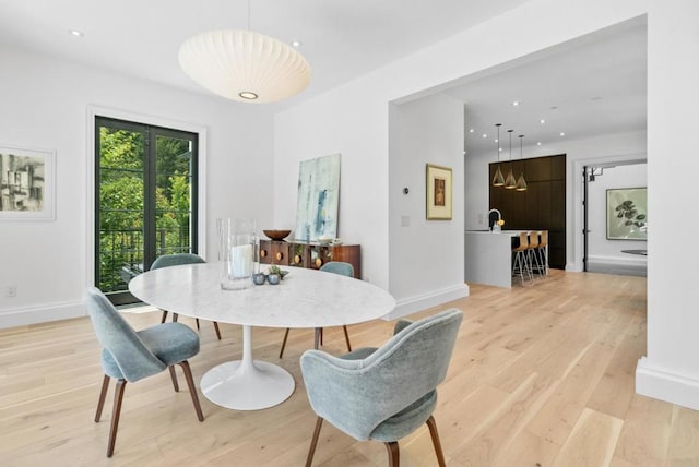 dining space with light hardwood / wood-style flooring