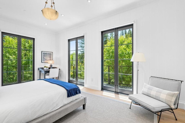 bedroom featuring ornamental molding and light hardwood / wood-style floors