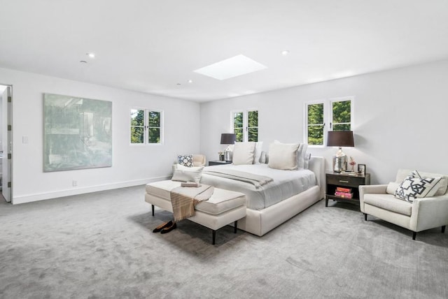 carpeted bedroom featuring a skylight