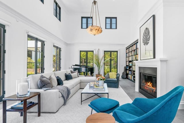 living room with ornamental molding and a towering ceiling