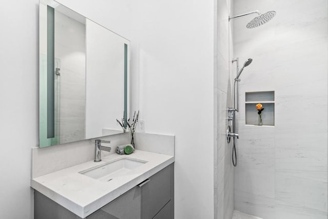 bathroom featuring vanity and a tile shower