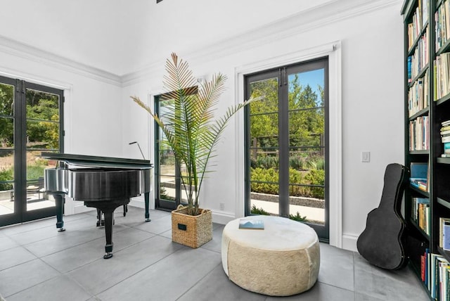 living area with ornamental molding, a healthy amount of sunlight, and french doors