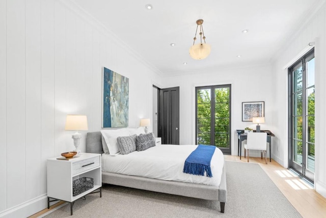 bedroom featuring multiple windows, crown molding, access to outside, and light hardwood / wood-style floors