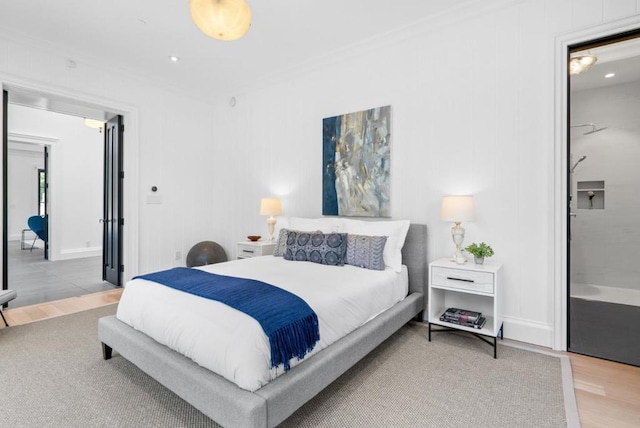 bedroom with crown molding and hardwood / wood-style floors