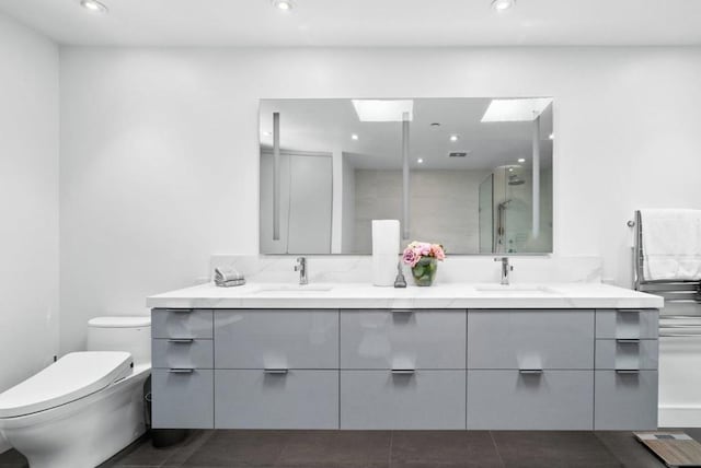 bathroom with vanity, an enclosed shower, tile patterned flooring, and toilet