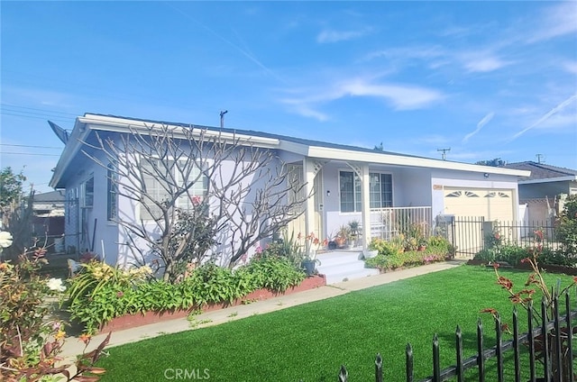 view of front of property featuring a garage and a front yard