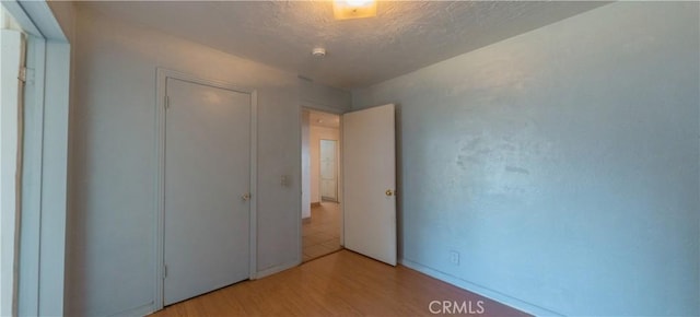 unfurnished bedroom featuring light wood-type flooring