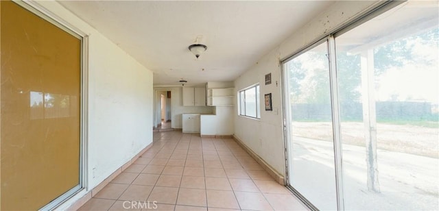 hallway with light tile patterned floors