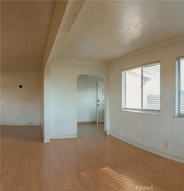 unfurnished room with ornamental molding and light hardwood / wood-style flooring