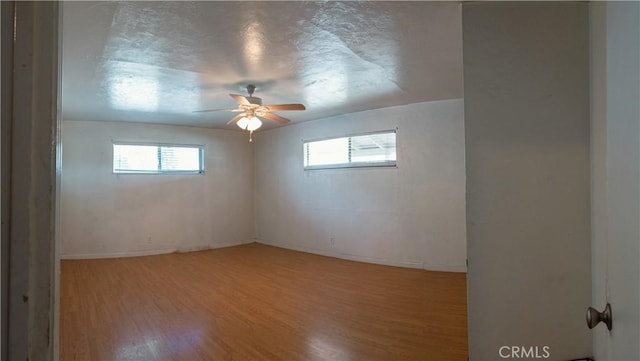 spare room with a textured ceiling and hardwood / wood-style flooring