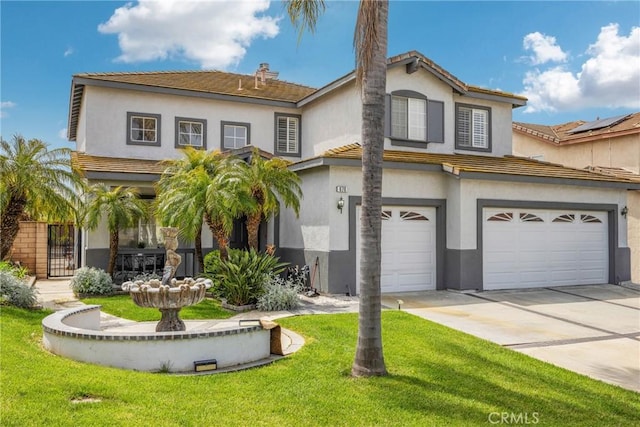 view of front of property with a front yard and a garage