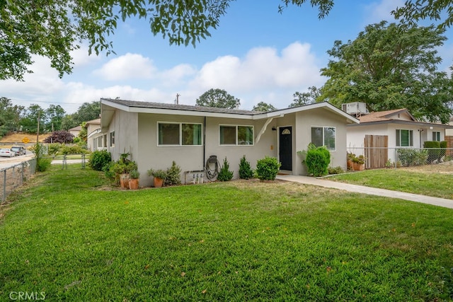 ranch-style home with a front lawn