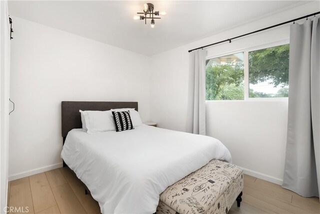 bedroom with hardwood / wood-style flooring