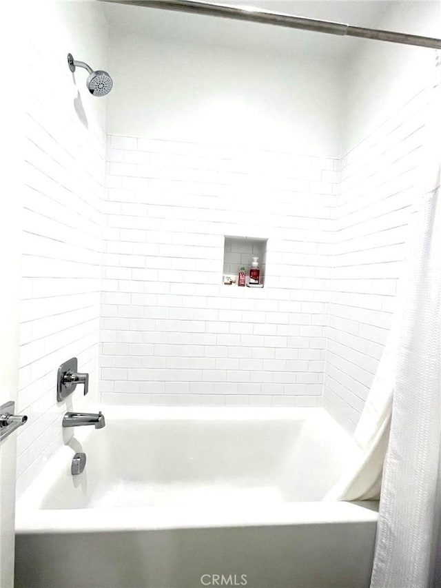 bathroom with shower / bathtub combination with curtain