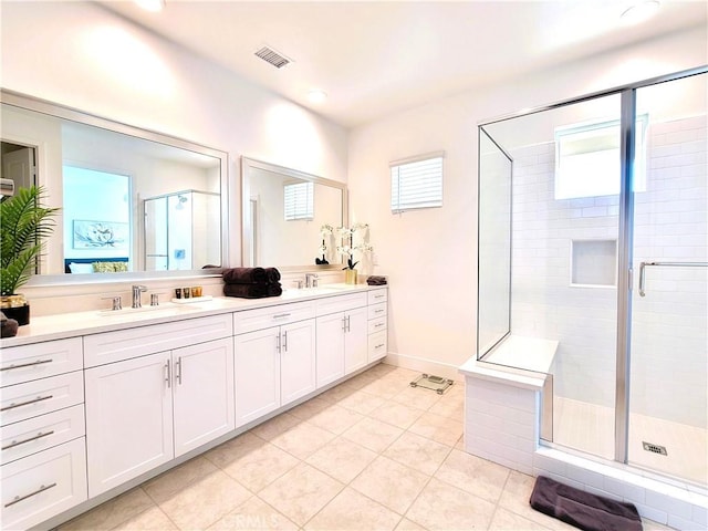 bathroom featuring tile patterned floors, vanity, and a shower with door