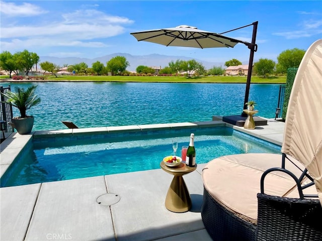 view of pool with a water and mountain view