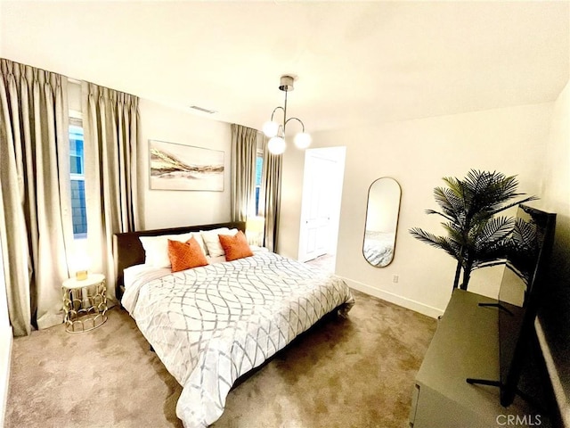 bedroom with carpet flooring and a chandelier