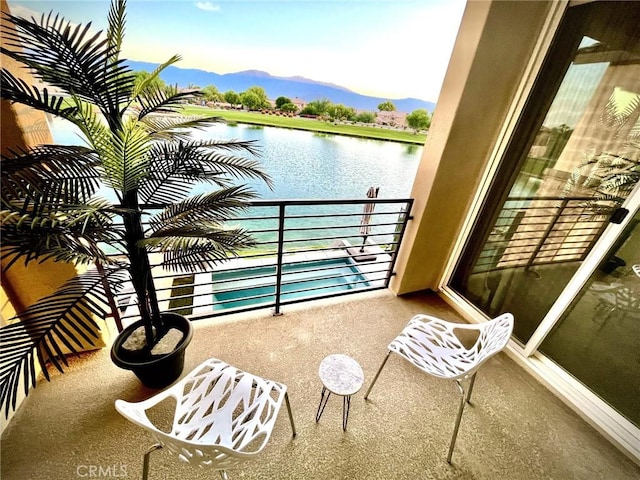 balcony with a water and mountain view