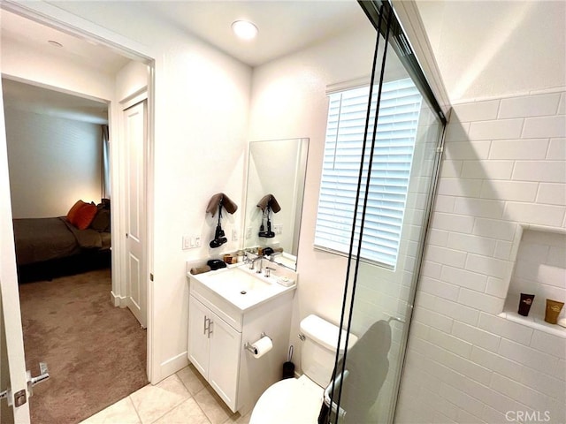 bathroom featuring tile patterned floors, walk in shower, vanity, and toilet