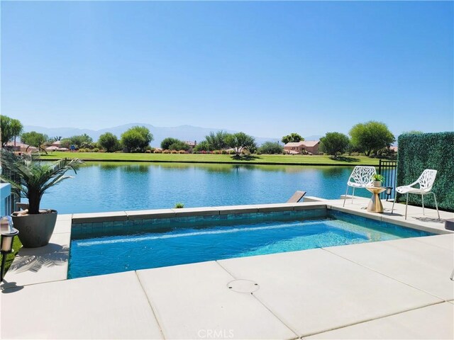 view of pool featuring a patio, pool water feature, and a water and mountain view