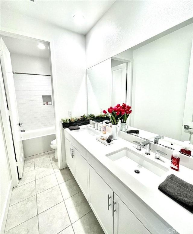 full bathroom with tile patterned flooring, vanity, toilet, and tiled shower / bath