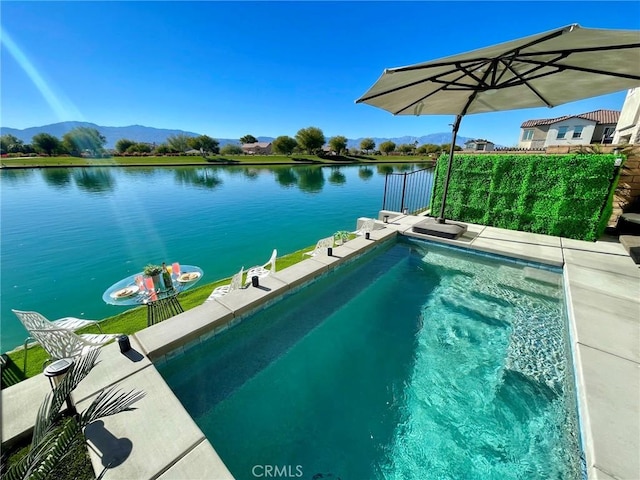 view of swimming pool featuring a water and mountain view