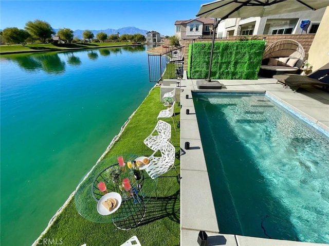 view of pool with a water view